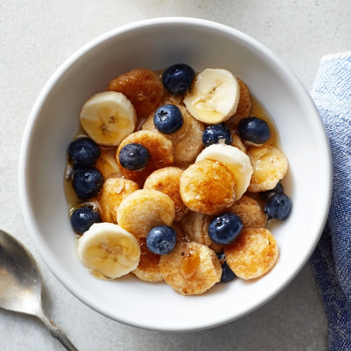 Delicious bite-sized Mini Pancake Cereal, crispy and fluffy, ready for breakfast.  