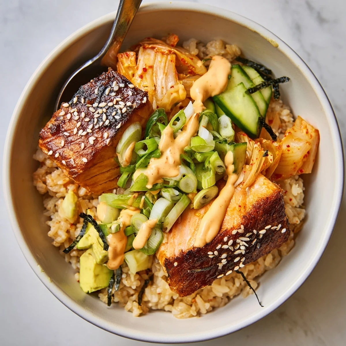Brightly colored Crispy Salmon Rice Bowl, featuring golden salmon and fresh cucumber slices.