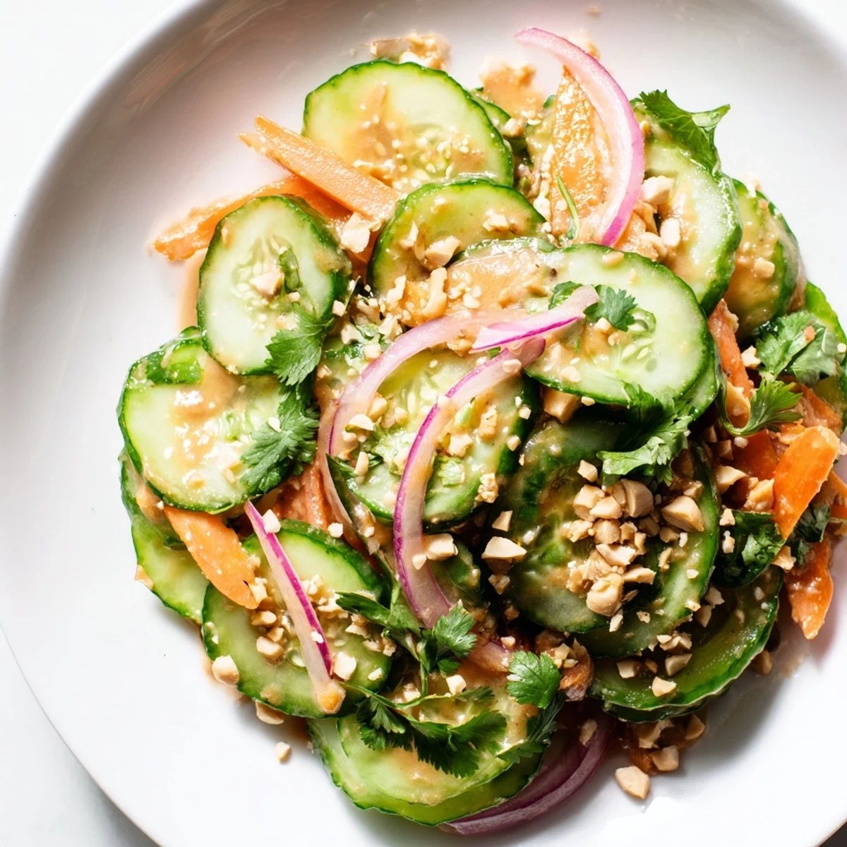 Brightly colored Thai-Style Peanut Cucumber Salad: crisp cucumbers in a creamy peanut dressing.