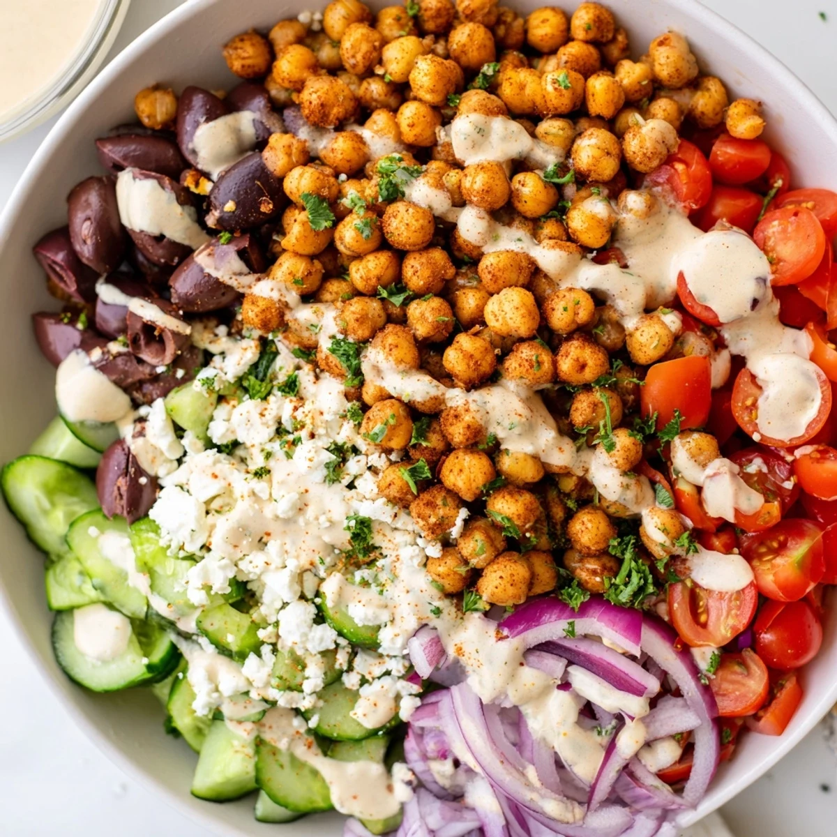 A flavorful closeup shows a delicious Mediterranean Chickpea Bowl served with lemon wedges and feta.