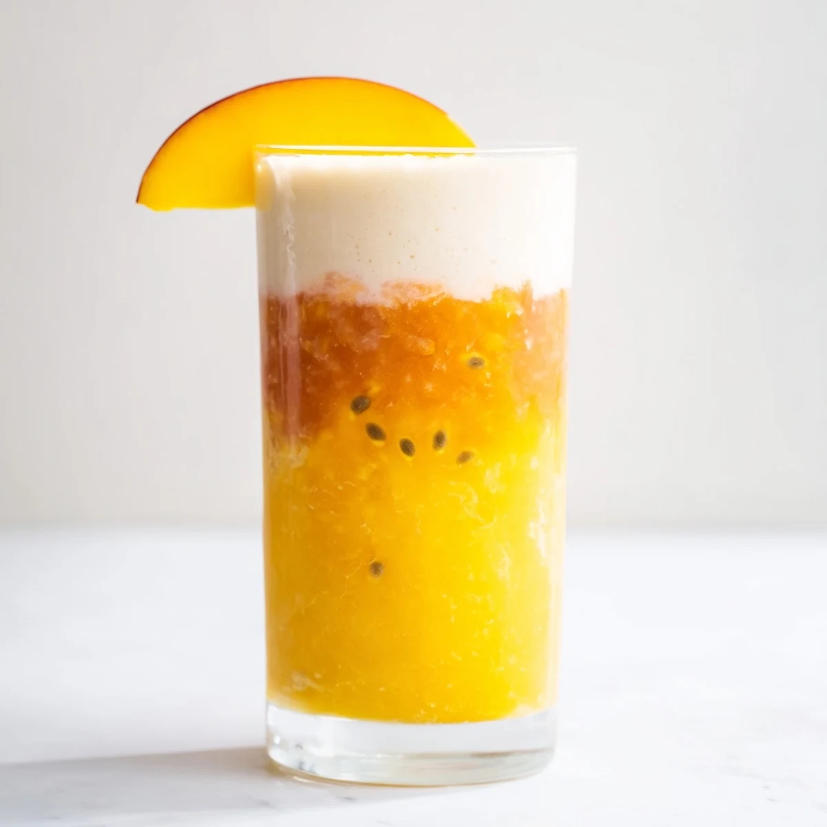 Cool, refreshing Tropical Sunset Smoothie - a beautiful summer beverage with creamy yogurt layers.