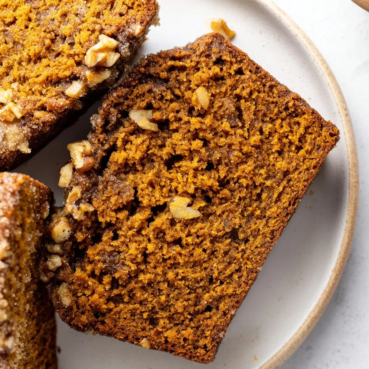 A warm, spiced pumpkin bread loaf, perfectly baked and ready to be served for breakfast.