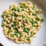 Close-up of Macaroni & Peas: tender pasta with sweet peas and Parmesan cheese.