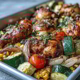 Vibrant Sheet Pan Chicken with Zucchini and Corn, featuring golden-brown chicken breasts surrounded by summer vegetables and fresh herbs.
