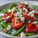 Sweet strawberries and baby spinach tossed with crunchy nuts, topped with tangy balsamic vinaigrette for a refreshing spring salad.  