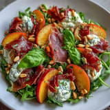 Creamy burrata and sweet peaches top this luscious Peach Burrata Prosciutto Salad.