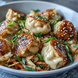 Sizzling Hot Honey Cabbage Dumpling Skillet, topped with fresh green onions and sesame seeds.