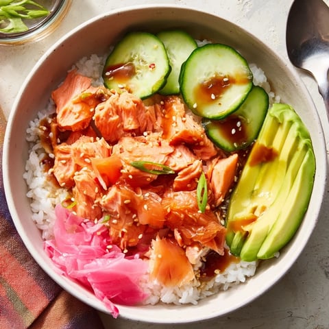 Delicious leftover salmon and rice bowl topped with fresh avocado and cucumbers.  