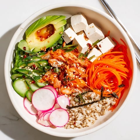 A colorful Fermented Vegetable Bowl topped with fresh avocado and crunchy radishes.  