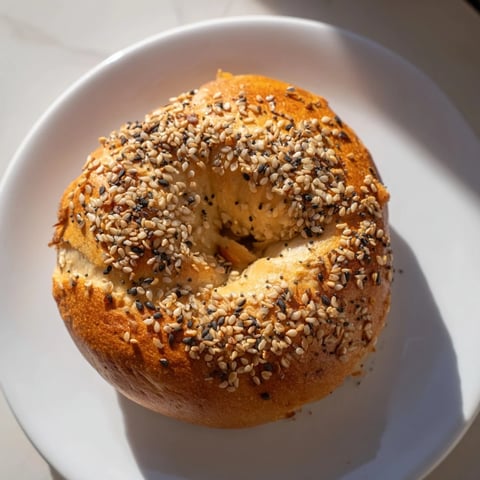 Golden brown Homemade Budget Bagels, warm from the oven, ready to be sliced and devoured.