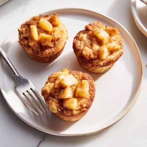 Golden brown cinnamon apple muffins, warm from the oven, ready for a delicious breakfast.