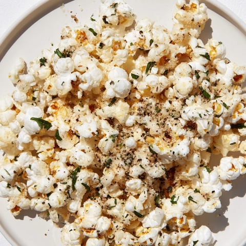 Golden-brown Savoury Popcorn Mix, perfectly seasoned with herbs, ready to enjoy as a delicious snack.