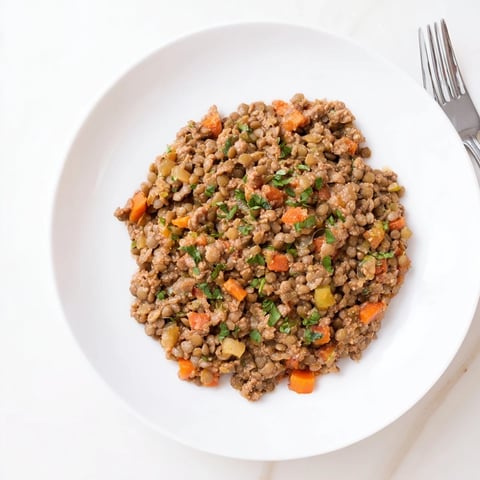 Creamy Tomato Basil Lentil Bolognese served over pasta, a comforting vegan Italian dish.
