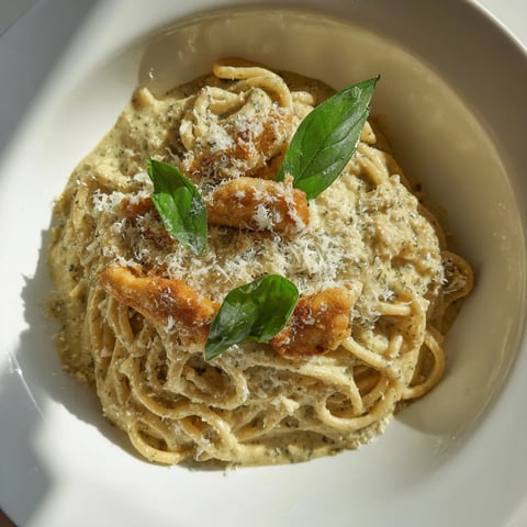 Golden chicken pieces mixed with pesto egg sauce in a delightful Pesto Egg and Chicken Pasta.