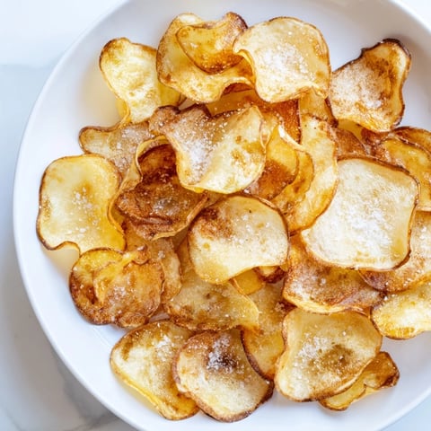 Crispy, golden homemade air-fryer potato chips ready to enjoy as a flavorful, easy snack.