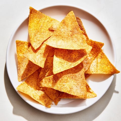 Golden, crispy Homemade Air-Fryer Tortilla Chips, perfect for scooping up fresh guacamole, with a salty crunch.