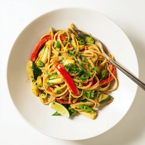 Steaming Thai Curry Pasta with colorful veggies, a fragrant and flavorful vegetarian meal.