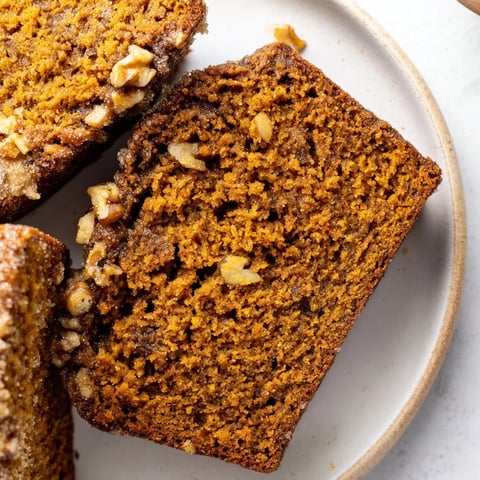 A warm, spiced pumpkin bread loaf, perfectly baked and ready to be served for breakfast.