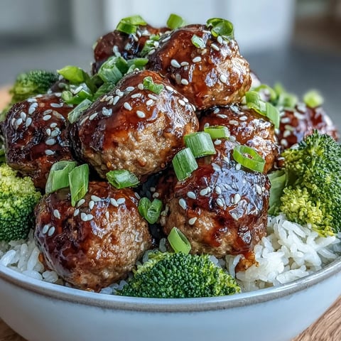 Honey Garlic Turkey Meatball Bowls feature juicy meatballs and tender broccoli over fluffy rice, drizzled with a glossy glaze.