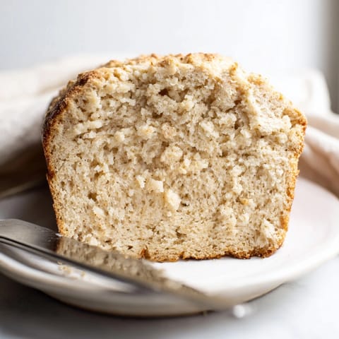 Rustic loaf of 2-Ingredient Cottage Cheese Bread; imagine the airy crumb and subtle tang.