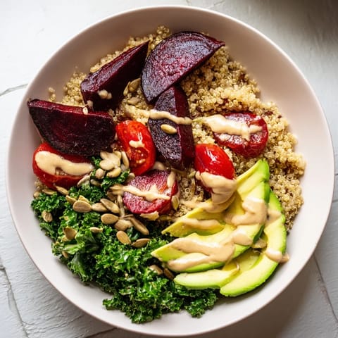 This photo features a healthy Quinoa, Kale & Roasted Beet Bowl, showcasing vibrant ingredients ready to eat.