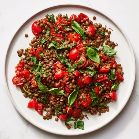 Vibrant image of a freshly made Lentil-Tomato Skillet, bursting with juicy tomatoes and spinach.