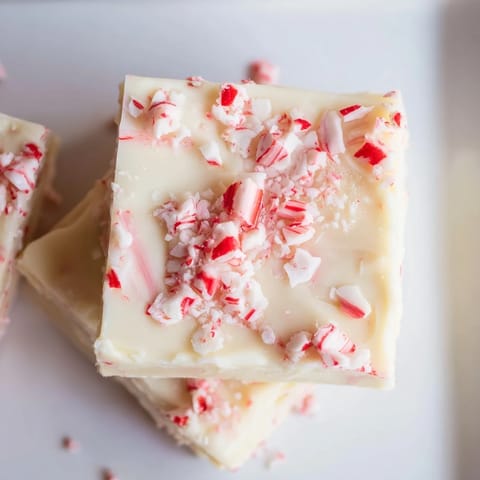 Delectable close-up of White Chocolate Peppermint Bark Fudge, a festive and quick holiday dessert to make.