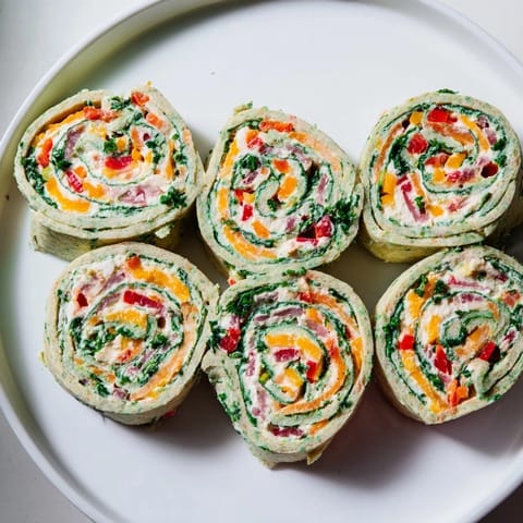 A close-up of the delicious Cozy Scarf Holiday Pinwheel Wraps; ready to eat and serve.