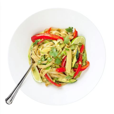 Creamy and delicious, this vibrant Thai Curry Pasta is served, ready to be enjoyed.