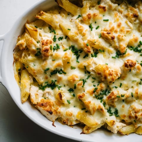 A hearty Chicken Ranch Pasta Bake with tender chicken, penne, and ranch sauce, garnished with green onions.