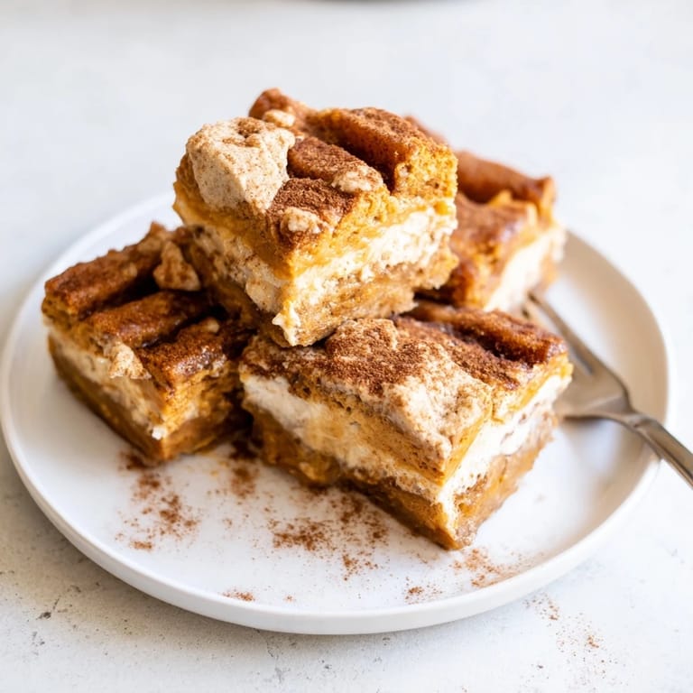 Delicious pumpkin cheesecake churro bars, a delightful treat for autumn celebrations and gatherings.