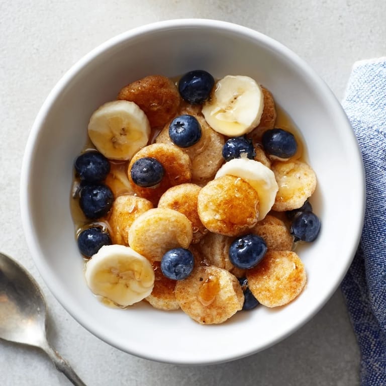 Delicious bite-sized Mini Pancake Cereal, crispy and fluffy, ready for breakfast.  