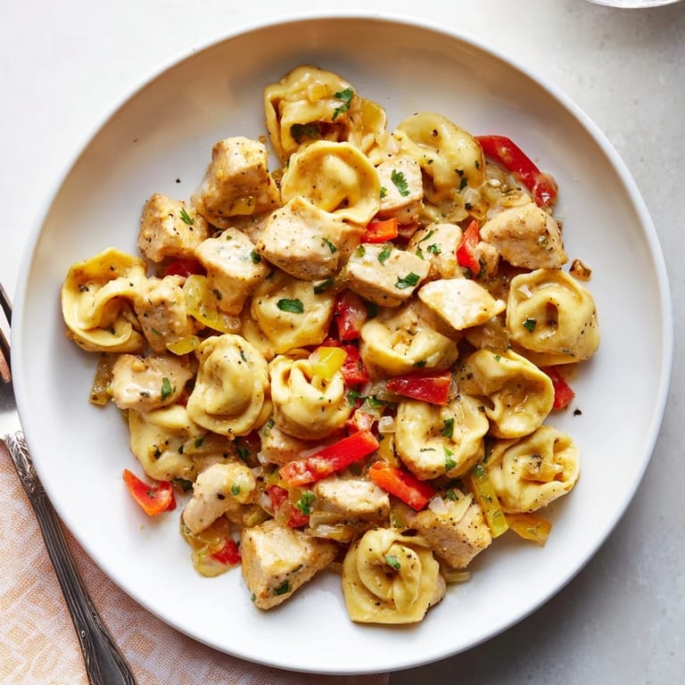 Sizzling Zesty Cajun Garlic Parmesan Chicken Tortellini, a rich and flavorful weeknight meal.