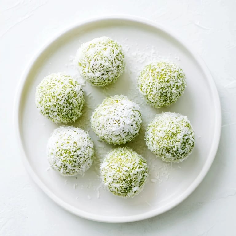 These creamy Coconut Matcha Snowball Fat Bombs are perfect keto snacks with vibrant green colors.