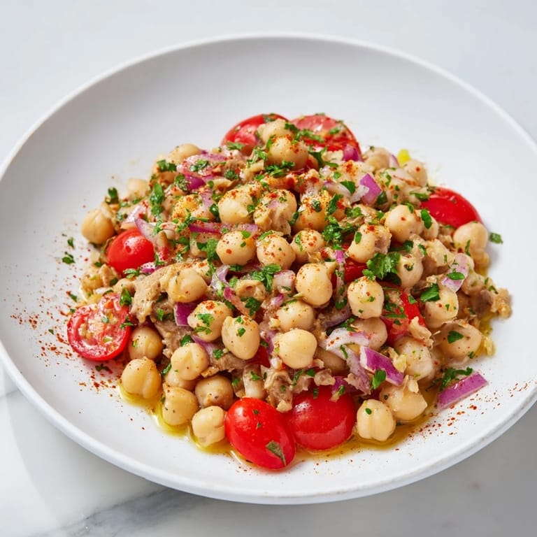Mediterranean-inspired Dense Chickpea and Tuna Salad, showcasing flaky tuna and chickpeas, plated and ready to eat.