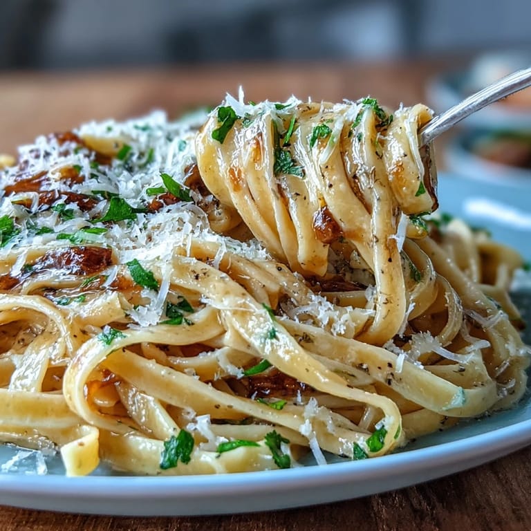 Delicate fresh egg pasta ribbons infused with truffle oil, served with a rich butter sauce and Parmesan.