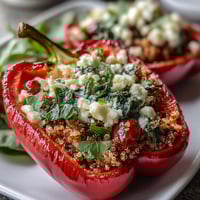 Vibrant stuffed bell peppers filled with quinoa, herbs, and vegetables, baked until tender and golden.