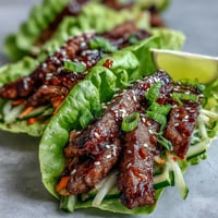 Korean BBQ beef lettuce wraps with vibrant, spicy kimchi and fresh veggies.