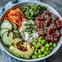 Vibrant canned tuna poke bowl with fresh veggies and zesty dressing, ready to eat.